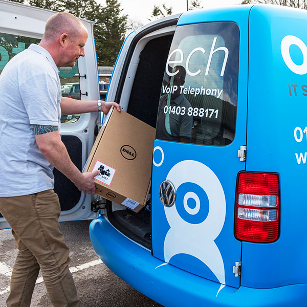 An Home IT Support technician prepares his van for a home visit.